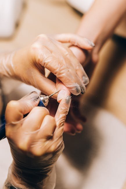 pexels-photo-4677851-4677851 Close-up of a manicure procedure with an electric nail file, showcasing precision and care.